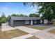 Single-story home featuring a well-manicured lawn with mature trees at 219 Marion Oaks Ln, Ocala, FL 34473
