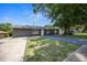 Charming single-story home with gray siding, a lush front yard, and a driveway at 219 Marion Oaks Ln, Ocala, FL 34473