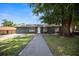 Charming single-story home with a well-maintained front yard, walkway, and mature tree at 219 Marion Oaks Ln, Ocala, FL 34473