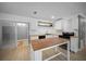 Well-appointed kitchen with a butcher block island, white cabinets, and modern appliances at 219 Marion Oaks Ln, Ocala, FL 34473