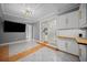 Bright kitchen featuring white cabinets, modern lighting, and sliding glass doors to the exterior at 219 Marion Oaks Ln, Ocala, FL 34473