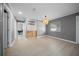 Open living area with light wood floors, a decorative pendant light, and built-in shelves at 219 Marion Oaks Ln, Ocala, FL 34473