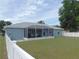 A screened-in porch adds extra space to this property, surrounded by a well-maintained backyard with a privacy fence at 2909 Ne 25Th St, Ocala, FL 34470