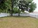 Private backyard featuring a vinyl privacy fence and mature trees at 2909 Ne 25Th St, Ocala, FL 34470