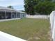 Expansive backyard featuring lush green grass and mature shade trees, complemented by a white privacy fence at 2909 Ne 25Th St, Ocala, FL 34470