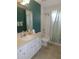 Well-lit bathroom with vanity, mirror, tub and shower at 2909 Ne 25Th St, Ocala, FL 34470