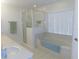 Bathroom showcasing a tub, and separate glass enclosed shower at 2909 Ne 25Th St, Ocala, FL 34470