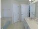 Bright bathroom featuring a soaking tub, tile flooring and a vanity with mirror at 2909 Ne 25Th St, Ocala, FL 34470