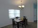 Cozy dining room featuring a chandelier and a bright window at 2909 Ne 25Th St, Ocala, FL 34470