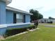 Charming home featuring a manicured lawn, flowering shrub, and neat landscaping at 2909 Ne 25Th St, Ocala, FL 34470