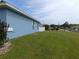 Exterior of a house with a large, green lawn and a partial view of a white fence at 2909 Ne 25Th St, Ocala, FL 34470