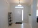Bright foyer featuring tile floors, an arched transom window, and an adjacent dining area at 2909 Ne 25Th St, Ocala, FL 34470