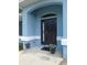 Close up of the home's entrance with elegant front door, complemented by decorative flower pots and manicured landscaping at 2909 Ne 25Th St, Ocala, FL 34470