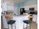 Modern kitchen with white cabinets, breakfast bar, and black appliances at 2909 Ne 25Th St, Ocala, FL 34470