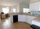 Well-lit kitchen featuring white cabinets and tiled floors, adjoining the office area at 2909 Ne 25Th St, Ocala, FL 34470