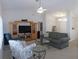 Inviting living room featuring vaulted ceiling, ceiling fan, and comfortable seating arrangement at 2909 Ne 25Th St, Ocala, FL 34470