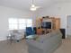 Bright living room with vaulted ceiling, ceiling fan, and entertainment center at 2909 Ne 25Th St, Ocala, FL 34470