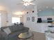 Cozy living room with ceiling fan, and breakfast bar leading into the kitchen area at 2909 Ne 25Th St, Ocala, FL 34470