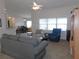 Open living room with neutral carpet, ceiling fan, and adjoined with an office area at 2909 Ne 25Th St, Ocala, FL 34470