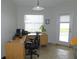 A tidy office room featuring a large window, a desk, and a computer at 2909 Ne 25Th St, Ocala, FL 34470