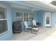 Relaxing covered patio with comfortable seating, ceiling fan, and a grill for outdoor cooking at 2909 Ne 25Th St, Ocala, FL 34470