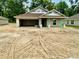 New construction home featuring a two-car garage and concrete block construction at 3131 Ne 46Th Ave, Ocala, FL 34470