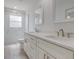 This bathroom features a marble-style tiled shower and dual vanity sinks with quartz counters at 400 Mariion Oaks Crse, Ocala, FL 34473