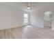 Large bedroom featuring light wood flooring, a window, ceiling fan, and ensuite bathroom at 400 Mariion Oaks Crse, Ocala, FL 34473