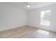 Spacious bedroom with light wood flooring, a ceiling fan, and a bright window at 400 Mariion Oaks Crse, Ocala, FL 34473