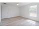 Bright bedroom features a ceiling fan, window, light wood flooring, and a white door at 400 Mariion Oaks Crse, Ocala, FL 34473