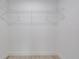 Walk-in closet featuring minimalist white shelving and light wood flooring at 400 Mariion Oaks Crse, Ocala, FL 34473