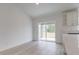 Open dining area with sliding glass doors to patio, light wood flooring and modern design at 400 Mariion Oaks Crse, Ocala, FL 34473