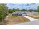 A charming single-Gathering home boasts a manicured lawn and concrete driveway with a fresh construction next door at 400 Mariion Oaks Crse, Ocala, FL 34473