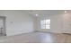 Spacious living room with plenty of natural light, light wood flooring, and access to laundry room at 400 Mariion Oaks Crse, Ocala, FL 34473