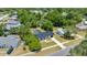 Aerial view of a home with a dark metal roof surrounded by lush greenery in a residential neighborhood at 4095 Sw 144Th St, Ocala, FL 34473