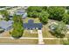 Aerial view of a charming single-story home featuring a black metal roof and well-manicured lawn in a quiet neighborhood at 4095 Sw 144Th St, Ocala, FL 34473