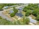 Aerial view showcasing a charming single-Gathering home with a dark metal roof and lush green surroundings in a quiet neighborhood at 4095 Sw 144Th St, Ocala, FL 34473