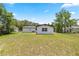 Backyard view showing the home's well kept lawn at 4095 Sw 144Th St, Ocala, FL 34473