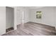 Bedroom with modern wood flooring, fresh paint and sliding closet doors at 4095 Sw 144Th St, Ocala, FL 34473
