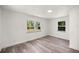 Bright bedroom with neutral walls and modern wood flooring complemented by dual windows at 4095 Sw 144Th St, Ocala, FL 34473