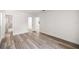 A bedroom featuring new floors, white walls, and two entry doors providing access to the bathroom at 4095 Sw 144Th St, Ocala, FL 34473