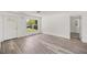 Bright living room with new floors, white walls, and natural light streaming through a large window at 4095 Sw 144Th St, Ocala, FL 34473