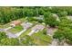 Aerial view of home with pool, storage shed, lush trees, and proximity to neighborhood amenities at 5263 Nw 62Nd Nw Ave, Ocala, FL 34482