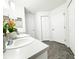 Bathroom featuring dual sinks, stone floors, and multiple storage options at 5263 Nw 62Nd Nw Ave, Ocala, FL 34482