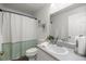Bright bathroom featuring a shower with curtain, single sink vanity, and decor at 5263 Nw 62Nd Nw Ave, Ocala, FL 34482