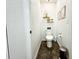 Cozy half bathroom with a modern toilet, decorative shelves, and unique floor tiling at 5263 Nw 62Nd Nw Ave, Ocala, FL 34482