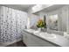 Bathroom featuring a double sink vanity, a large mirror, and a shower with a floral curtain at 5263 Nw 62Nd Nw Ave, Ocala, FL 34482