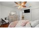 Bedroom featuring wood floors, ceiling fan, dresser with a mirror and closet creating a cozy and functional space at 5263 Nw 62Nd Nw Ave, Ocala, FL 34482