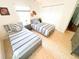 Well-lit shared bedroom with two twin beds, neutral colors, sports decor, and carpeted floors at 5263 Nw 62Nd Nw Ave, Ocala, FL 34482