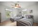 Bright bedroom with two twin beds, windows, and neutral decor creating a serene and inviting atmosphere at 5263 Nw 62Nd Nw Ave, Ocala, FL 34482